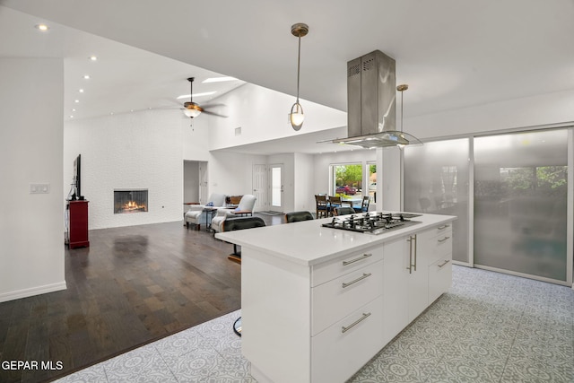 10121 Monaco Dr, El Paso, TX 79925 - kitchen with white cabinets, a kitchen island, stainless steel gas cooktop, modern cabinets, and ceiling fan