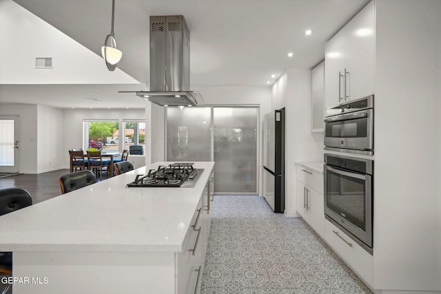 10121 Monaco Dr, El Paso, TX 79925 - kitchen with stainless steel appliances, a center island, island range hood, recessed lighting, and white cabinetry
