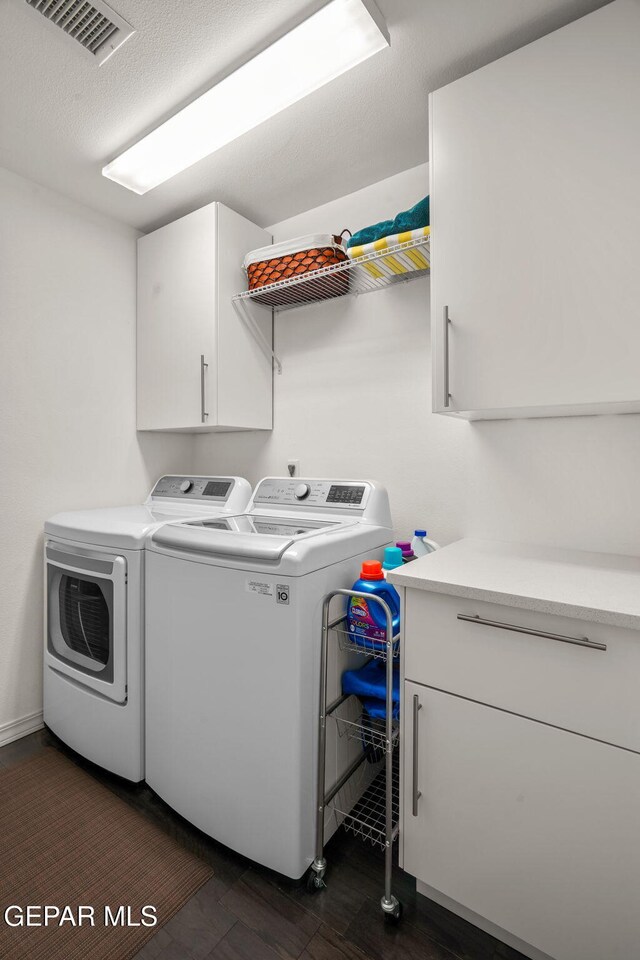 10121 Monaco Dr, El Paso, TX 79925 - laundry room featuring independent washer and dryer, cabinet space, and dark wood-style floors