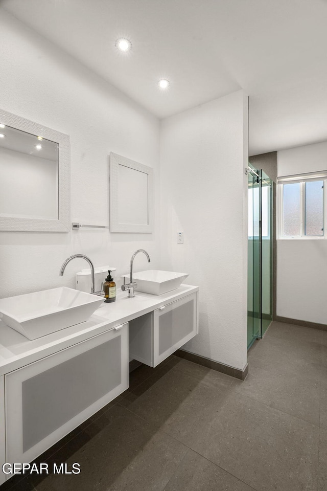 10121 Monaco Dr, El Paso, TX 79925 - bathroom featuring double vanity, recessed lighting, and a stall shower