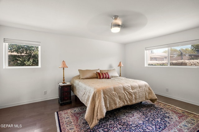 10121 Monaco Dr, El Paso, TX 79925 - bedroom featuring multiple windows, wood finished floors, and a ceiling fan