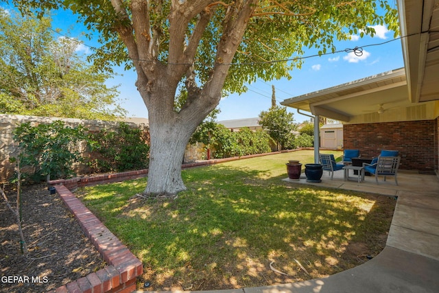 10121 Monaco Dr, El Paso, TX 79925 - fenced backyard featuring a ceiling fan, a patio area, and a storage unit