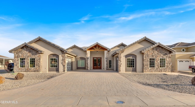 1042 Castillo Ct, El Paso, TX 79932 - view of front facade with stone siding, decorative driveway, stucco siding, and an attached garage