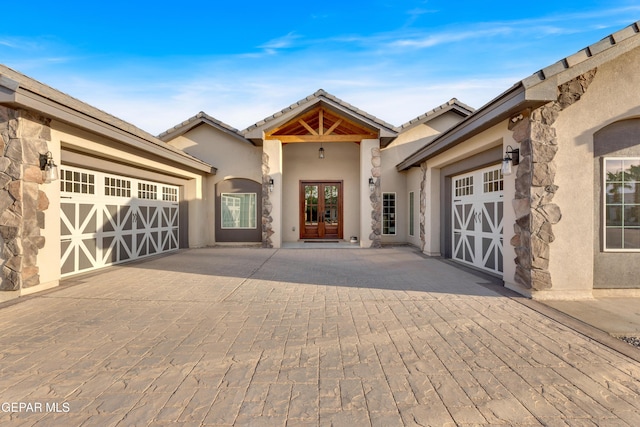1042 Castillo Ct, El Paso, TX 79932 - doorway to property featuring an attached garage, french doors, and decorative driveway
