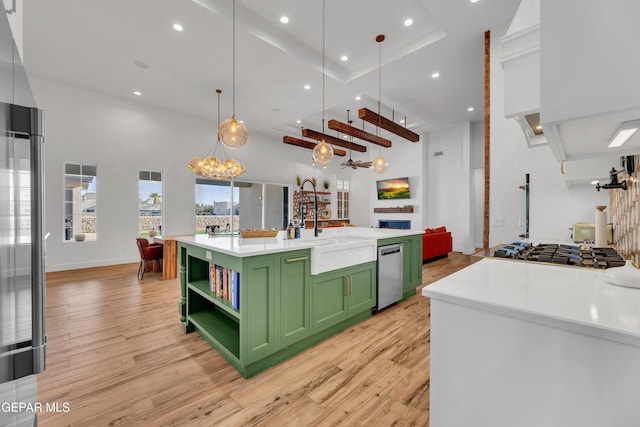 1042 Castillo Ct, El Paso, TX 79932 - kitchen with green cabinetry, appliances with stainless steel finishes, open shelves, light wood-type flooring, and recessed lighting