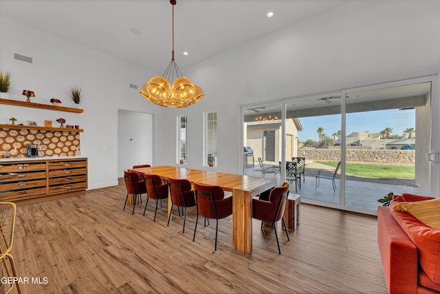 1042 Castillo Ct, El Paso, TX 79932 - dining space with light wood-style flooring, a chandelier, a towering ceiling, and recessed lighting