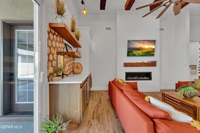 1042 Castillo Ct, El Paso, TX 79932 - living room featuring a ceiling fan, light wood finished floors, and a fireplace