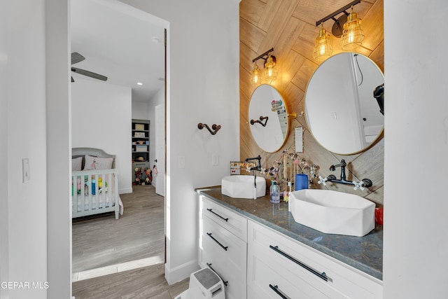 1042 Castillo Ct, El Paso, TX 79932 - ensuite bathroom with double vanity, wood finished floors, and wooden walls