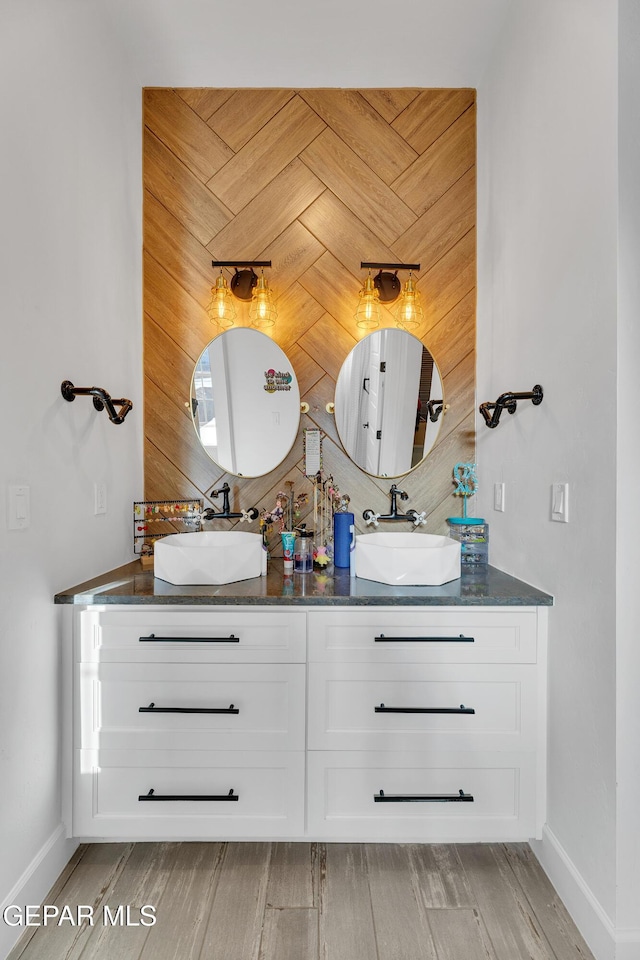 1042 Castillo Ct, El Paso, TX 79932 - full bathroom with double vanity and wood finished floors