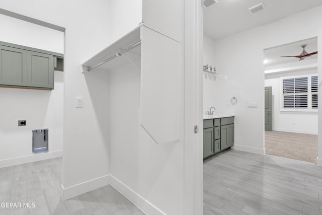 837 Paseo Serra Ct, El Paso, TX 79928 - laundry room with electric dryer hookup, light wood-style floors, cabinet space, and ceiling fan