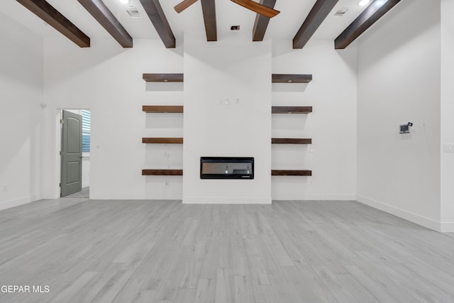 837 Paseo Serra Ct, El Paso, TX 79928 - unfurnished living room with ceiling fan, beamed ceiling, light wood-style flooring, and a towering ceiling