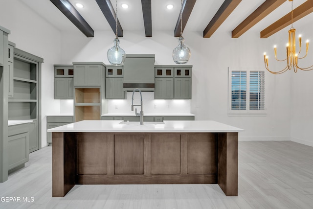 837 Paseo Serra Ct, El Paso, TX 79928 - kitchen with beamed ceiling, a large island with sink, light wood-style floors, a chandelier, and light countertops