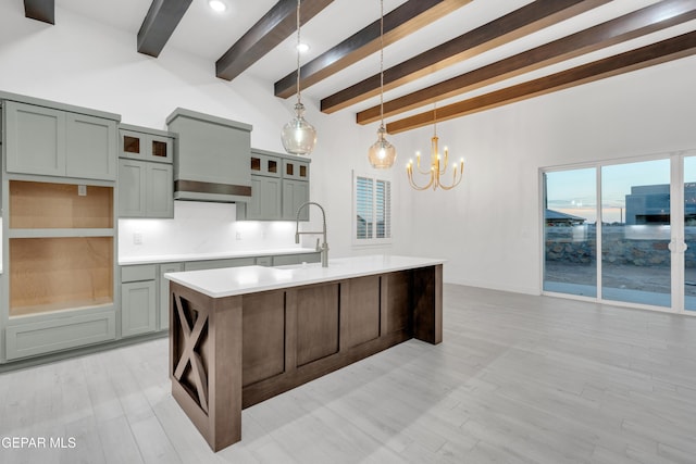 837 Paseo Serra Ct, El Paso, TX 79928 - kitchen featuring beamed ceiling, a chandelier, light countertops, a kitchen island with sink, and hanging light fixtures