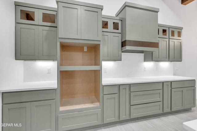 837 Paseo Serra Ct, El Paso, TX 79928 - kitchen with glass insert cabinets, custom exhaust hood, tasteful backsplash, and light countertops
