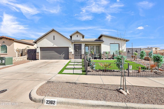 2362 Enchanted Crown Ln, El Paso, TX 79911 - view of front of property featuring stucco siding, driveway, an attached garage, and stone siding