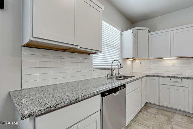 2362 Enchanted Crown Ln, El Paso, TX 79911 - kitchen with stainless steel dishwasher, light stone counters, white cabinets, and decorative backsplash