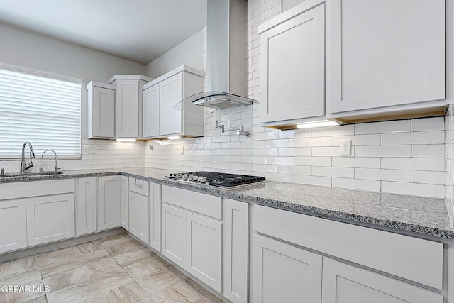2362 Enchanted Crown Ln, El Paso, TX 79911 - kitchen with wall chimney exhaust hood, stainless steel gas cooktop, light stone counters, and white cabinetry