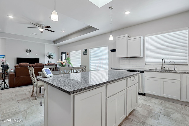 2362 Enchanted Crown Ln, El Paso, TX 79911 - kitchen with stainless steel dishwasher, light marble finish floors, a kitchen island, stone counters, and recessed lighting