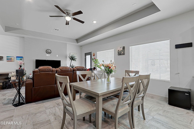 2362 Enchanted Crown Ln, El Paso, TX 79911 - dining space featuring a raised ceiling, light marble finish floors, and ceiling fan