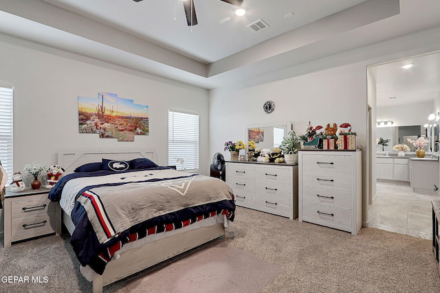 2362 Enchanted Crown Ln, El Paso, TX 79911 - bedroom with multiple windows, light colored carpet, and ensuite bathroom