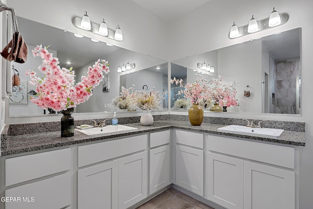 2362 Enchanted Crown Ln, El Paso, TX 79911 - bathroom featuring double vanity, a tile shower, and tile patterned floors