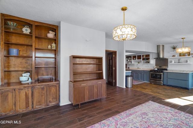 6604 Camino Fuente Dr, El Paso, TX 79912 - kitchen with open shelves, gas range, a chandelier, exhaust hood, and dark wood finished floors