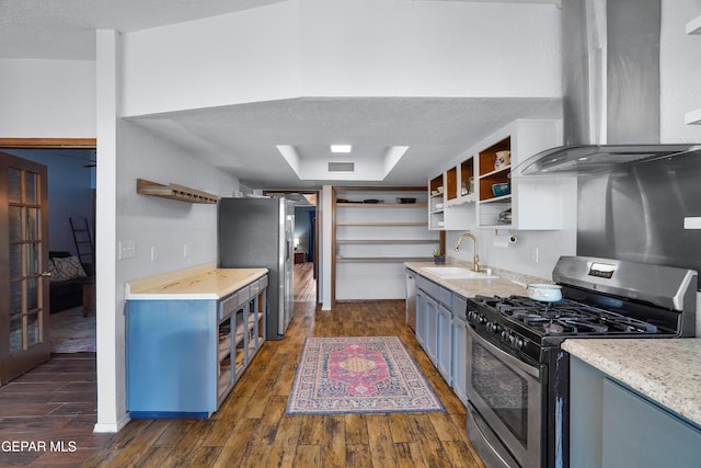 6604 Camino Fuente Dr, El Paso, TX 79912 - kitchen with appliances with stainless steel finishes, open shelves, extractor fan, dark wood finished floors, and a textured ceiling