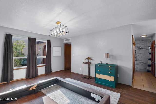 6604 Camino Fuente Dr, El Paso, TX 79912 - living area with a textured ceiling, wood finished floors, and a chandelier