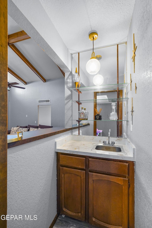 6604 Camino Fuente Dr, El Paso, TX 79912 - bathroom with a textured wall, vanity, and a textured ceiling