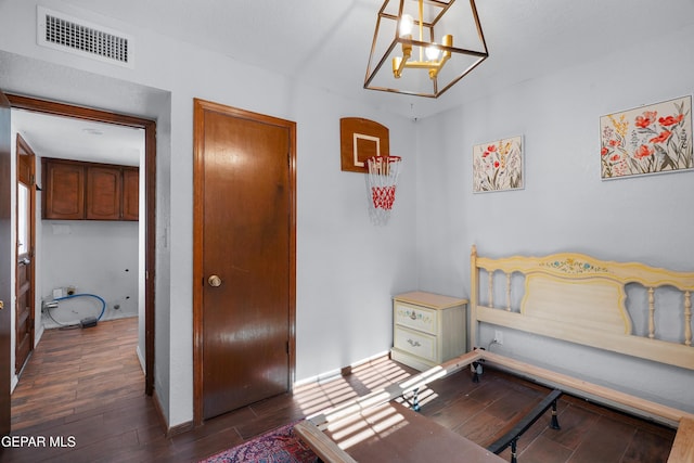 6604 Camino Fuente Dr, El Paso, TX 79912 - bedroom with wood finished floors and a chandelier