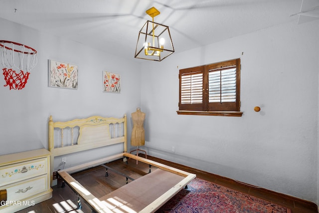 6604 Camino Fuente Dr, El Paso, TX 79912 - bedroom with wood finished floors and a chandelier