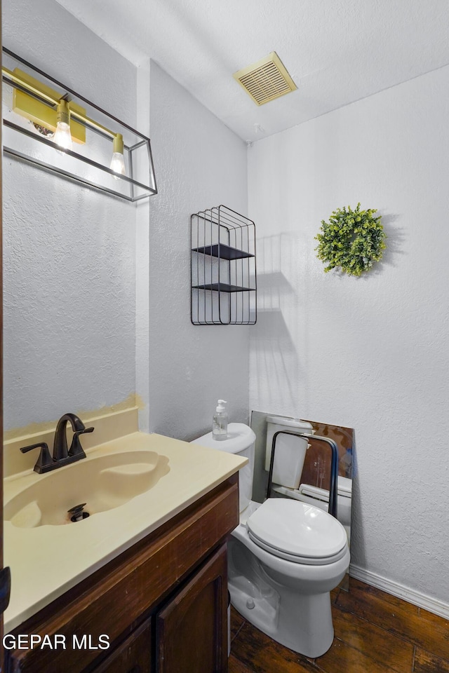 6604 Camino Fuente Dr, El Paso, TX 79912 - bathroom with wood finished floors, vanity, and a textured wall