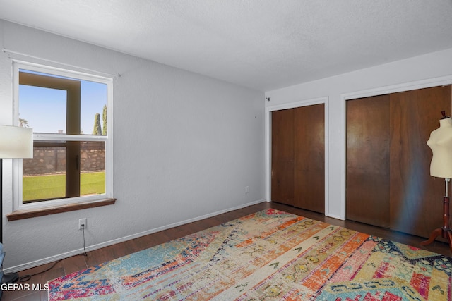 6604 Camino Fuente Dr, El Paso, TX 79912 - unfurnished bedroom with two closets and wood finished floors