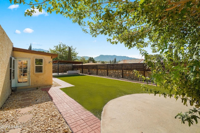 6604 Camino Fuente Dr, El Paso, TX 79912 - fenced backyard with a mountain view and a patio area