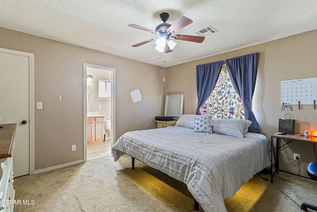 13344 Jonathan Elias Ct, El Paso, TX 79938 - bedroom featuring light colored carpet, a ceiling fan, connected bathroom, and a textured ceiling