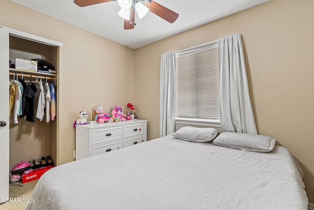 13344 Jonathan Elias Ct, El Paso, TX 79938 - carpeted bedroom with a closet, a ceiling fan, and a textured ceiling