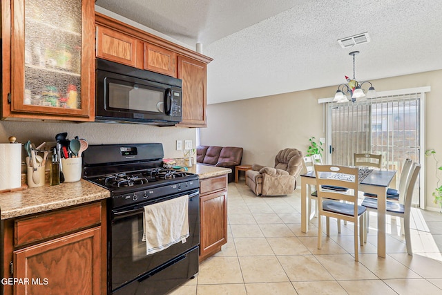 13344 Jonathan Elias Ct, El Paso, TX 79938 - kitchen with black appliances, light countertops, light tile patterned floors, pendant lighting, and brown cabinets