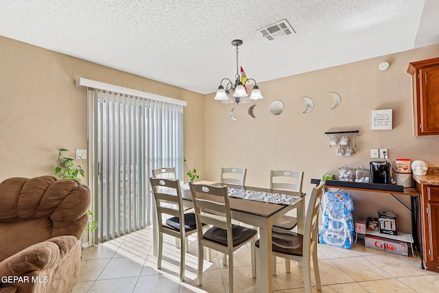 13344 Jonathan Elias Ct, El Paso, TX 79938 - dining area with light tile patterned floors, a chandelier, and a textured ceiling