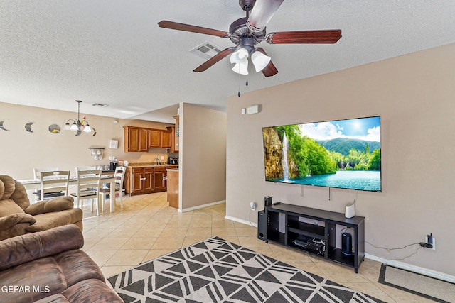 13344 Jonathan Elias Ct, El Paso, TX 79938 - living room with light tile patterned floors, ceiling fan, and a textured ceiling