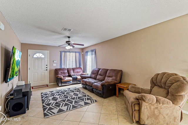 13344 Jonathan Elias Ct, El Paso, TX 79938 - living room featuring ceiling fan, light tile patterned flooring, and a textured ceiling