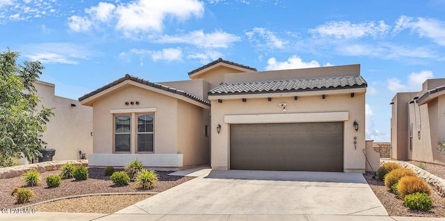 991 Hull St, El Paso, TX 79928 - mediterranean / spanish house with a garage, concrete driveway, stucco siding, and a tile roof