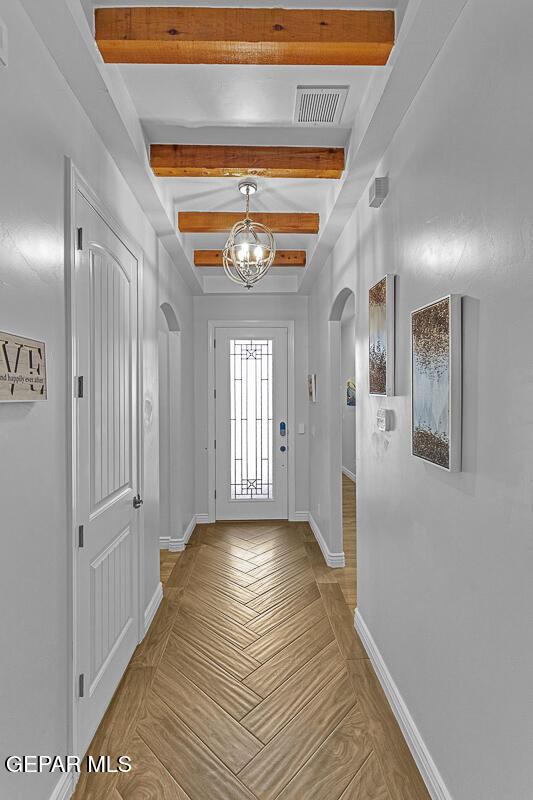 991 Hull St, El Paso, TX 79928 - foyer entrance with arched walkways, beamed ceiling, a chandelier, and parquet floors