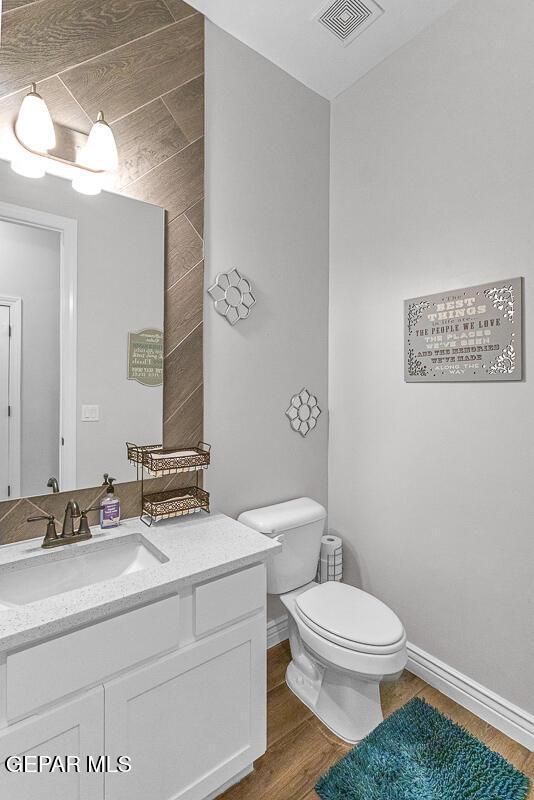 991 Hull St, El Paso, TX 79928 - half bathroom with vanity and wood finished floors