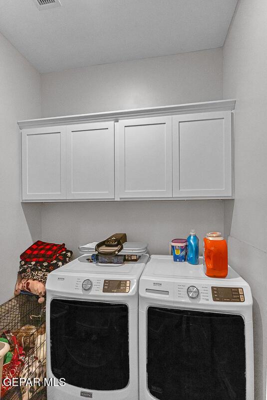 991 Hull St, El Paso, TX 79928 - washroom with separate washer and dryer and cabinet space