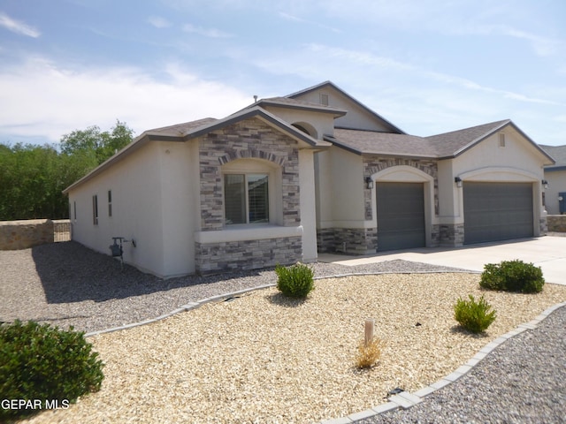929 Pecos River Dr, El Paso, TX 79932 - view of front of house with an attached garage, stone siding, concrete driveway, and stucco siding