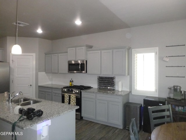 929 Pecos River Dr, El Paso, TX 79932 - kitchen with appliances with stainless steel finishes, dark wood-type flooring, tasteful backsplash, light stone countertops, and decorative light fixtures