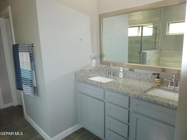 929 Pecos River Dr, El Paso, TX 79932 - bathroom featuring double vanity, a shower stall, and wood finished floors