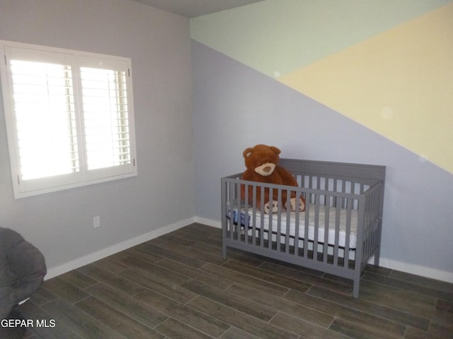 929 Pecos River Dr, El Paso, TX 79932 - bedroom featuring multiple windows, wood finished floors, and a crib