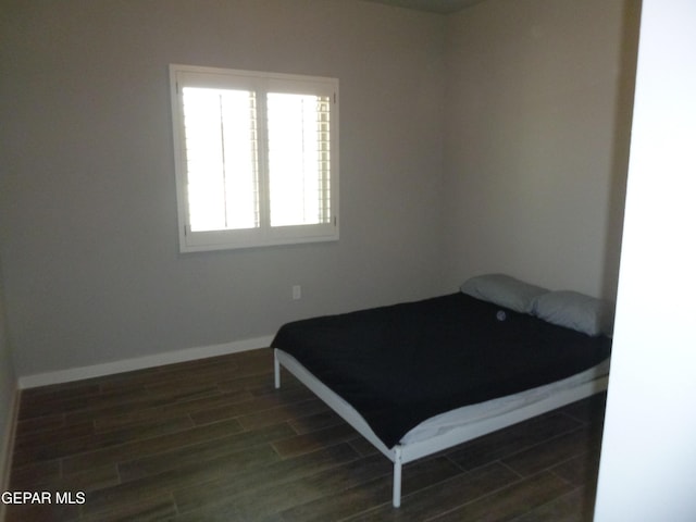 929 Pecos River Dr, El Paso, TX 79932 - bedroom featuring dark wood-style floors and baseboards