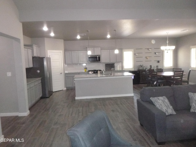 929 Pecos River Dr, El Paso, TX 79932 - kitchen with open floor plan, dark wood-style flooring, appliances with stainless steel finishes, a chandelier, and light countertops